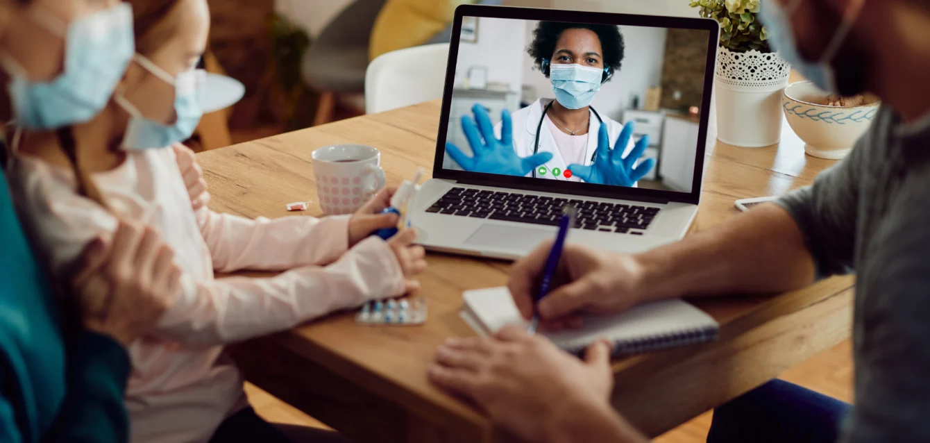 closeup-family-talking-with-doctor-via-video-call-laptop-coronavirus-pandemic