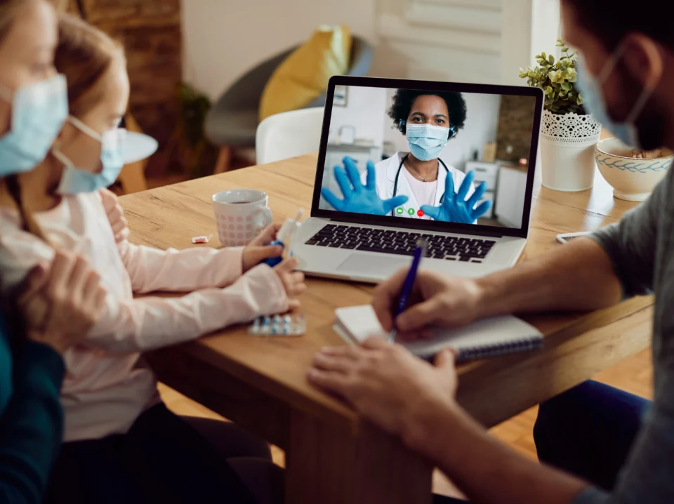 closeup-family-talking-with-doctor-via-video-call-laptop-coronavirus-pandemic